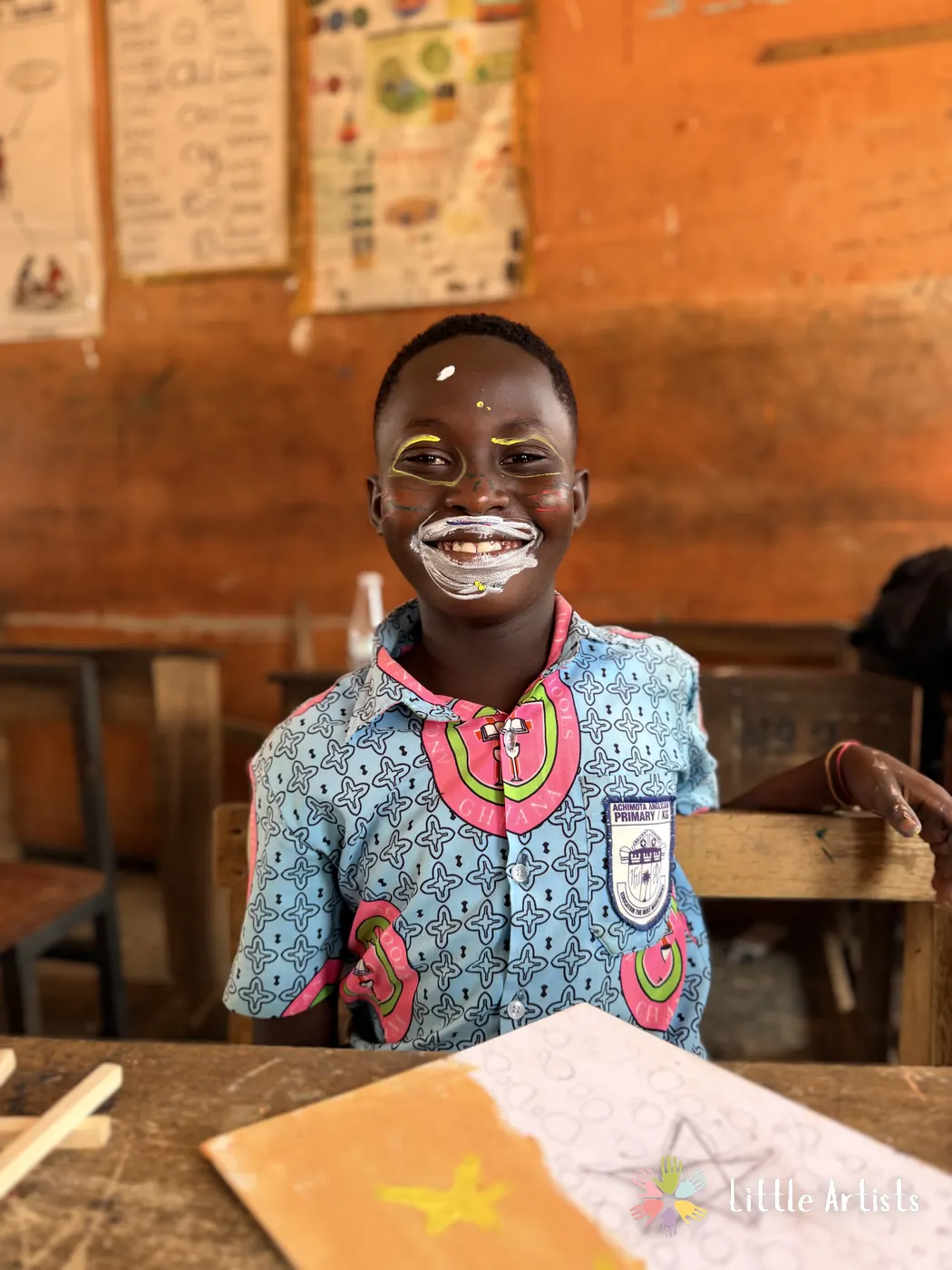 A student grinning with their face painted at the children's arts festival