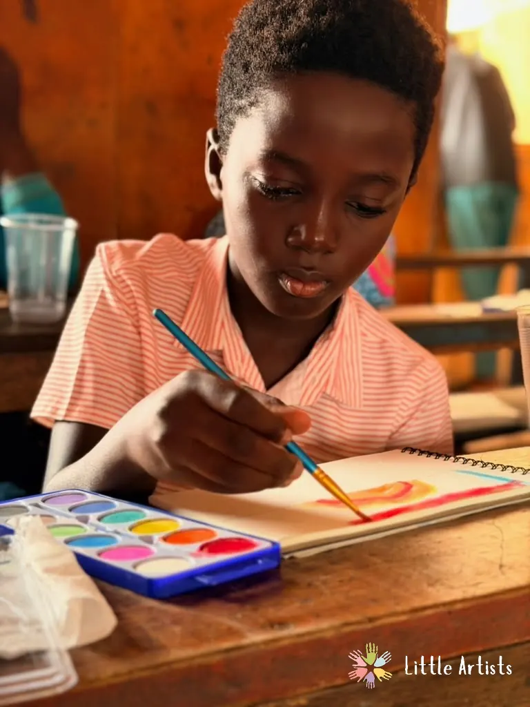 A student painting with watercolours in a sketchbook